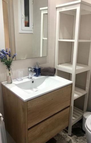a bathroom with a sink and a mirror at Vilamarlux III in Vilassar de Mar