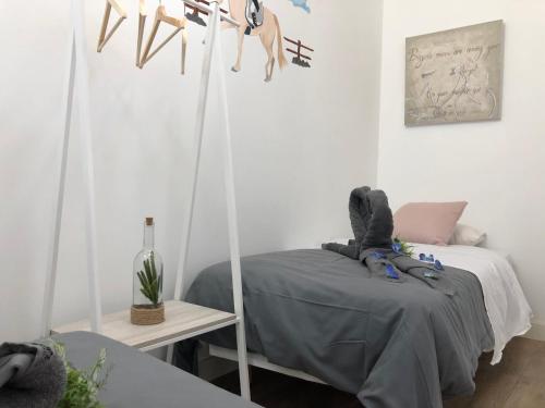 a bedroom with a bed with a gray blanket at Vilamarlux III in Vilassar de Mar