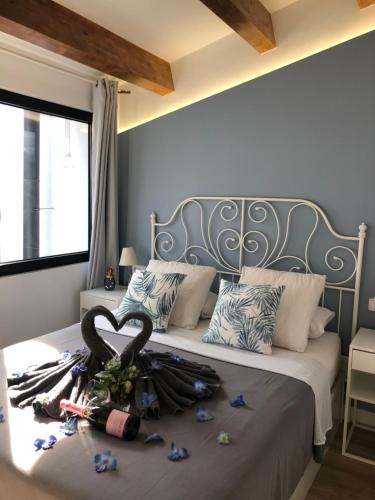 a bed with a heart made out of flowers on it at Vilamarlux III in Vilassar de Mar