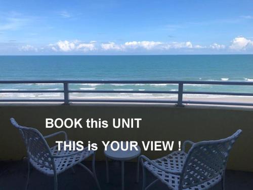 a balcony with two chairs and a view of the ocean at Ocean Walk Resort - Amazing Ocean Front View in Daytona Beach
