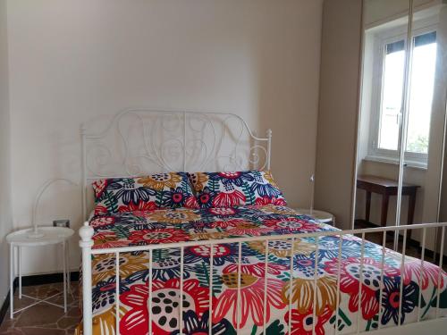 a bedroom with a bed with a colorful bedspread at Casa Tina in Santa Margherita Ligure