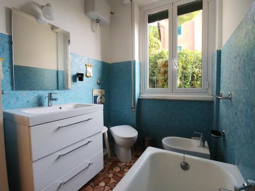 a bathroom with a sink and a toilet and a window at Casa Tina in Santa Margherita Ligure