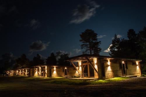 a cabin lit up at night with lights at Nordic Lapland Frevisören in Båtskärsnäs