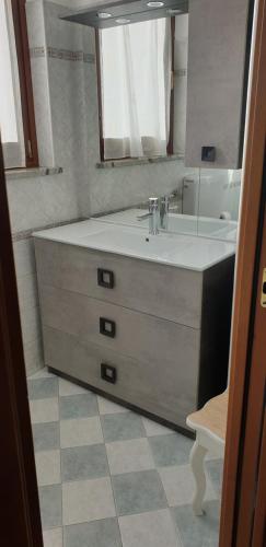 a bathroom with a sink and a mirror at B&B Chanoux in Aosta