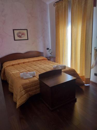 a bedroom with a bed with a table in it at River Hotel in Castel di Sangro