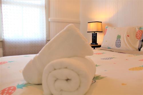 a towel animal on top of a bed at NEW - Pineapple Loft - Entire House Downtown Hilo with AC in Hilo