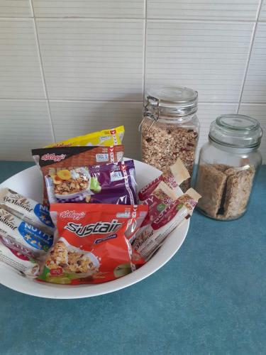 a plate of food on a table with some snacks at Charming country house close to Grafton in Waterview Heights