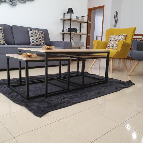 a coffee table in a living room with a couch and chairs at Black'nYellow Place in Vila Franca do Campo