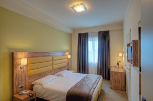 Posteľ alebo postele v izbe v ubytovaní Giga Hotel