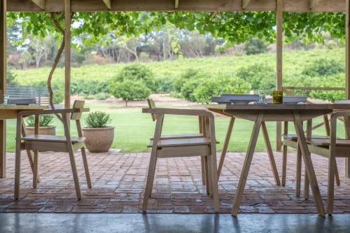 a table and chairs under an umbrella on a patio at McLaren Vale Getaways in McLaren Flat