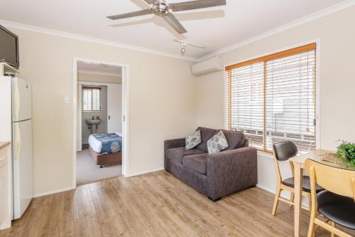 a living room with a couch and a table at Holiday Haven Kangaroo Valley in Kangaroo Valley