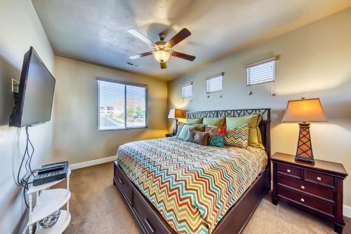 a bedroom with a bed and a flat screen tv at Mountain View Retreat: Paradise Village at Zion #39 in Santa Clara