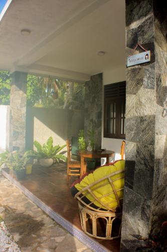 a living room with a yellow couch and a table at The Mango Leaf in Matara