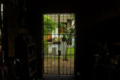 a door with a gate in a dark room at The Mango Leaf in Matara
