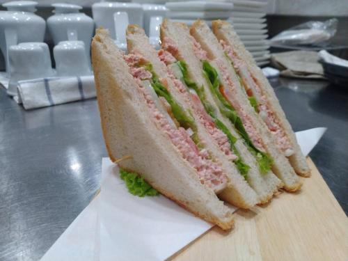 un sándwich se corta por la mitad en una tabla de cortar en NARITA amata, en Chonburi