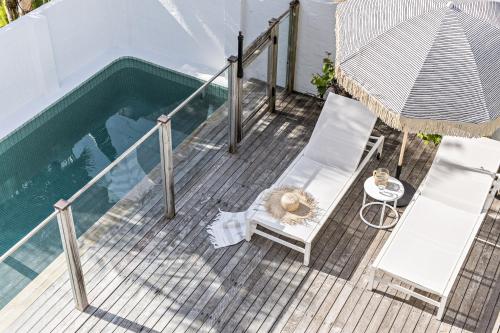 an overhead view of a deck with a swimming pool at Cape Beach House in Byron Bay