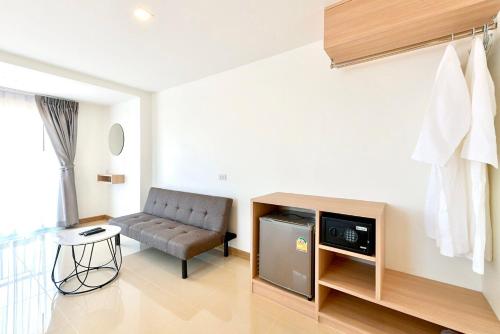 a living room with a couch and a chair at IRIS PALACE in Pattaya South