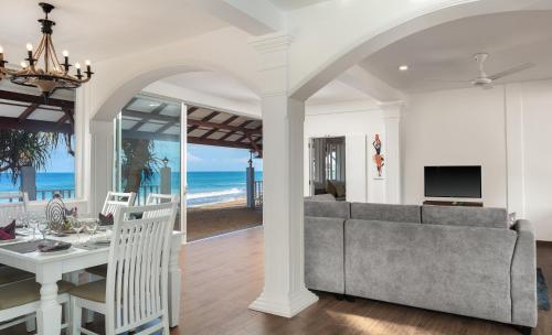 a living room with a couch and a table at Villa Mer Vue in Ambalangoda