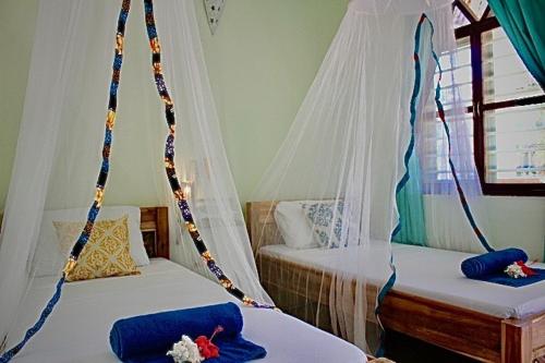 Posteľ alebo postele v izbe v ubytovaní Kiwengwa Bungalow Boutique Resort