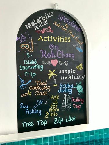 a chalkboard with writing on it in a bathroom at Watercolours in Ko Chang