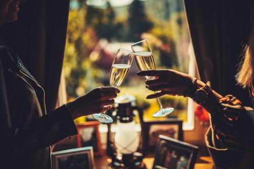 two people holding champagne glasses in their hands at Willa Barbara - ProHarmonia in Lądek-Zdrój