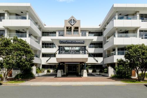 an apartment building with a clock on top of it at The Anchorage Apartments in Mount Maunganui