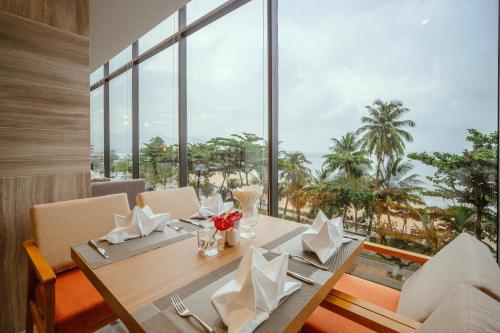 a dining room with a table with a view of the ocean at Navada Beach Hotel in Nha Trang