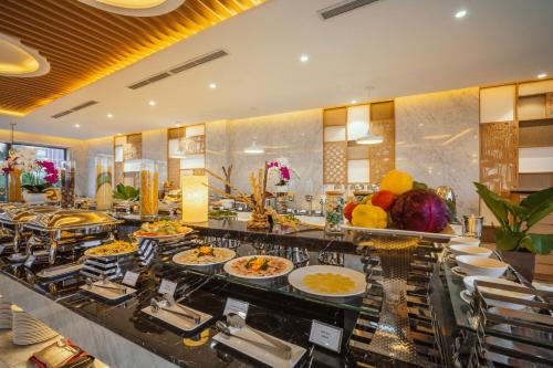 a buffet line with many plates of food at Navada Beach Hotel in Nha Trang