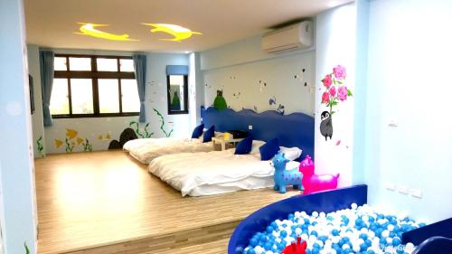 1 Schlafzimmer mit 2 Betten und einem Wandbild von Schmetterlingen in der Unterkunft 晚安熊-親子民宿 in Zhushan