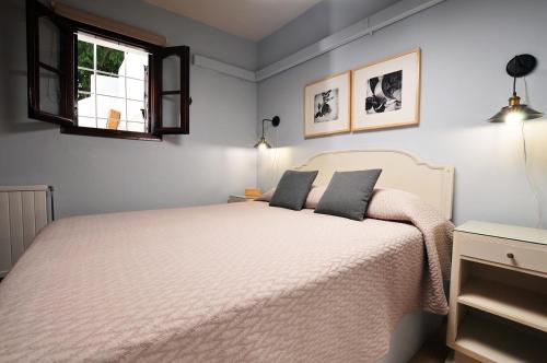 a bedroom with a white bed and a window at BLUE GREY cottage in Portaria