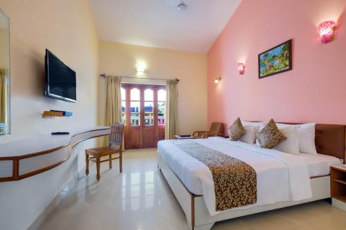 um quarto de hotel com uma cama e uma secretária em Spazio Leisure Resort, Goa em Anjuna