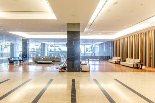 a lobby with couches and chairs in a building at Rex Ollie @ The Elements Ampang in Kuala Lumpur
