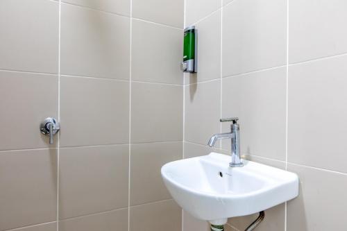 a white bathroom with a sink and a shower at Rex Ollie @ The Elements Ampang in Kuala Lumpur