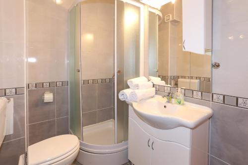 a bathroom with a toilet and a sink and a shower at Villa Luciana in Trogir