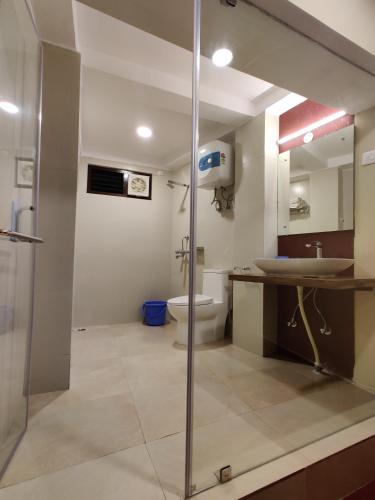 a bathroom with a shower and a sink and a toilet at Hotel Tarayana in Gangtok