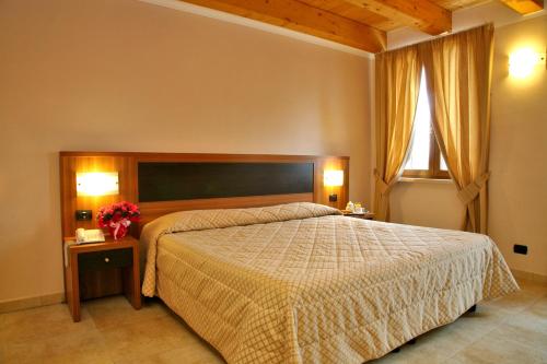 a bedroom with a large bed and a window at La Zerla in Bardolino