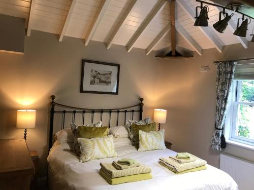 a bedroom with a bed with towels on it at Jockhedge Holiday Cottages in Skegness