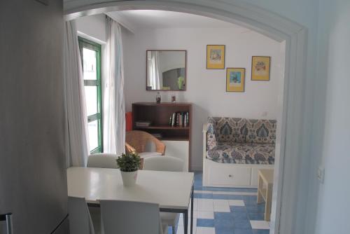 a living room with a table and a couch at HarbourPlaya de Mogan in Puerto de Mogán