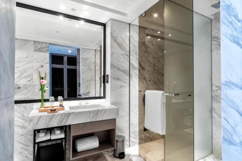 a bathroom with a sink and a mirror at Taj Jumeirah Lakes Towers in Dubai
