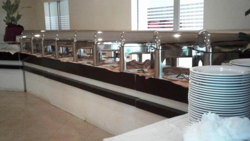 a buffet line with a bunch of pastries at Gamodh Citadel Resort in Anuradhapura
