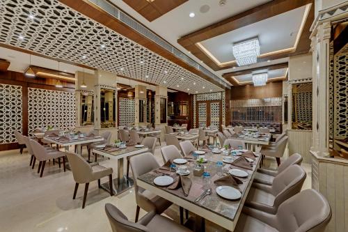 a restaurant with tables and chairs in a room at The Fern Residency Aurangabad - Chhatrapati Sambhaji Nagar in Aurangabad