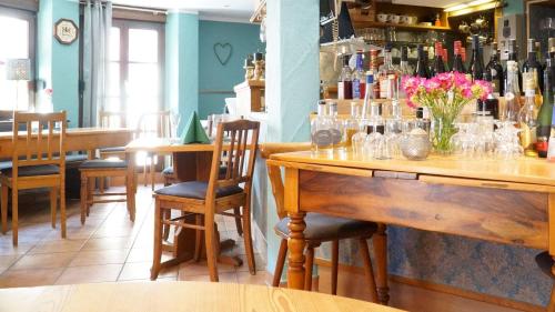 a restaurant with tables and chairs and a bar at Hotel Dalberg in Sankt Martin