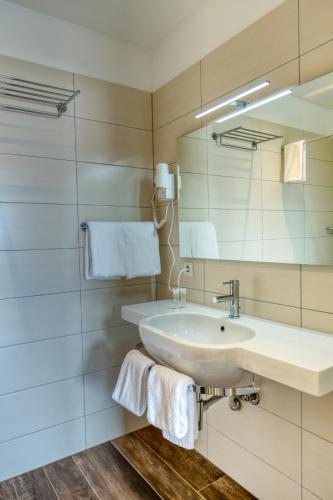 a bathroom with a sink and a mirror at Hotel 1001 Nott in Egilsstadir