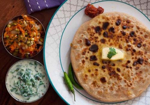 a plate of food with a stack of pancakes and dip at Hotel Maha Luxmi Palace in Katra