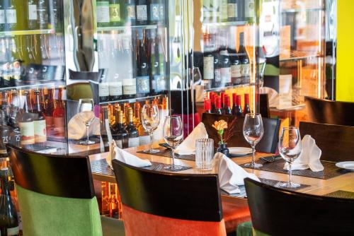 a table in a restaurant with wine glasses at Thon Hotel Bergen Airport in Bergen