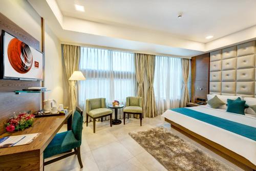Postel nebo postele na pokoji v ubytování Peerless Hotel Kolkata