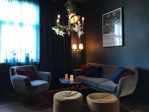 a living room with a couch and two chairs and a table at Örserumsbrunn Gestgifveri & Konferens in Gränna