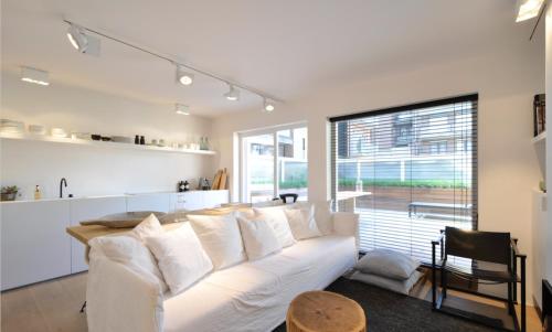 a living room with a white couch and a table at Julias Stay in Knokke-Heist