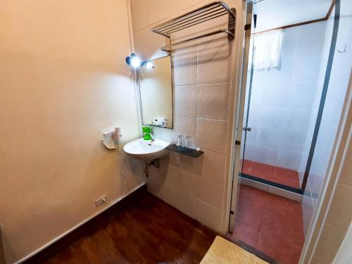 a small bathroom with a sink and a shower at Cocoloco Beach Resort in Boracay