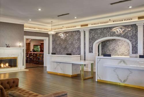 a lobby with a table and a fireplace at Seaview, A Dolce Hotel in Galloway